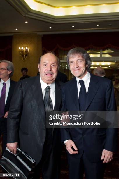 Italian actor and comedian Lino Banfi taking Italian director and producer Carlo Vanzina by the arm during the reception at the hotel Parco dei...