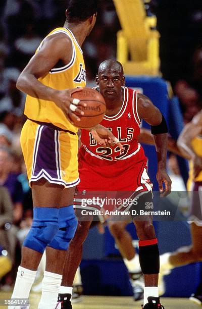 Michael Jordan of the Chicago Bulls defends against Magic Johnson of the Los Angeles Lakers during Game 5 of the 1991 NBA Championship Finals on June...
