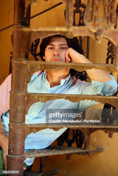 Portrait of Vittorio Sgarbi's son Carlo Sgarbi Brenner sitting on a winding staircase of Villa Banfi. Vimercate, 2000s.
