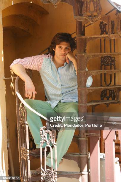 Vittorio Sgarbi's son Carlo Sgarbi Brenner sitting on a winding staircase of Villa Banfi. Vimercate, 2000s.