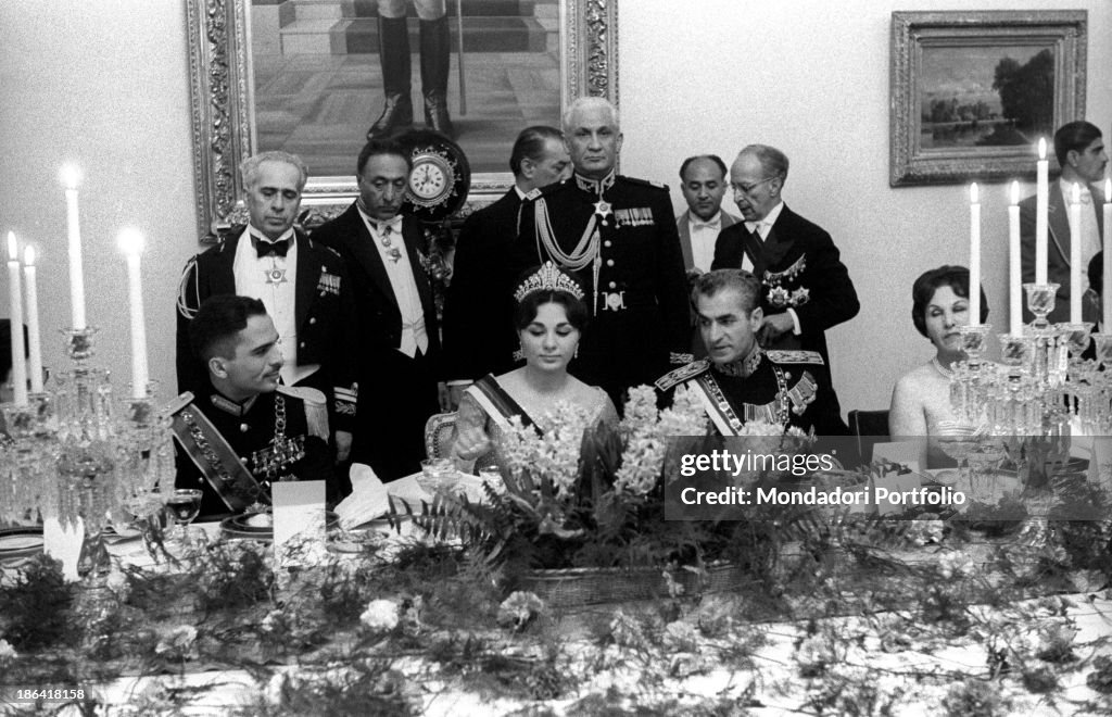 Farah Pahlavi, Hussein of Jordan and Mohammad Reza Pahlavi sitting at the table