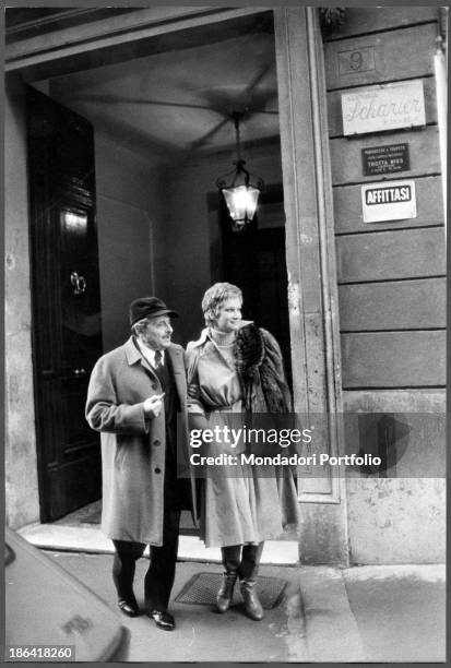 Italian director Alessandro Blasetti and Italian actress Carla Gravina walking in the street. Rome, 1974.