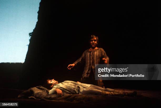 German bass Kurt Moll kneeling beside Bulgarian tenor Spas Wenkoff, playing the role of Tristan, in the opera Tristan und Isolde performed at La...