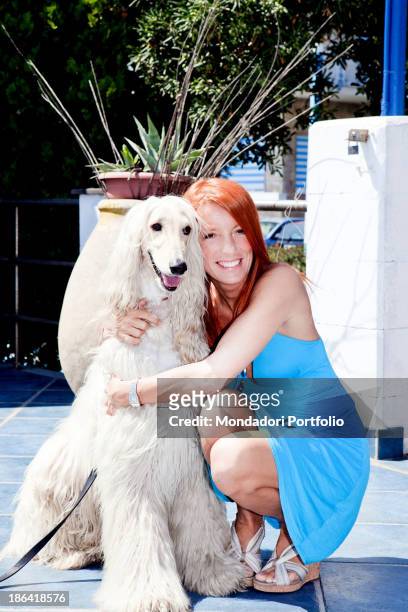 Italian politician and animalist Michela Vittoria Brambilla hugging an Afghan hound dog at the lido Bau Bau Village. Albisola Marina, 22nd August...
