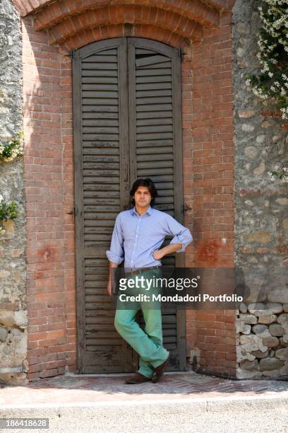 Vittorio Sgarbi's son Carlo Sgarbi Brenner leaning against a shutter of Villa Banfi. Vimercate, 2000s.