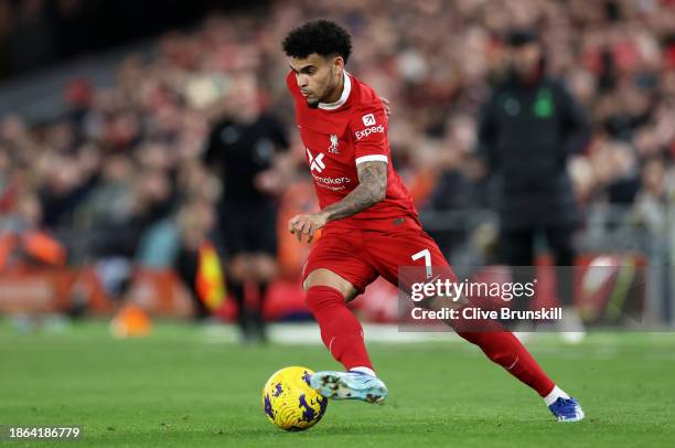 Luis Diaz of Liverpool runs with the ball during the Premier League match between Liverpool FC and Manchester United at Anfield on December 17, 2023...