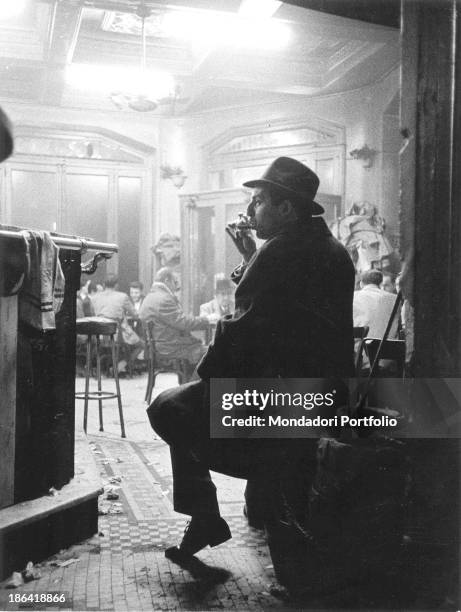 Man drinking an aperitif in an old bar on Gran Via in Madrid. Madrid, 1960s.