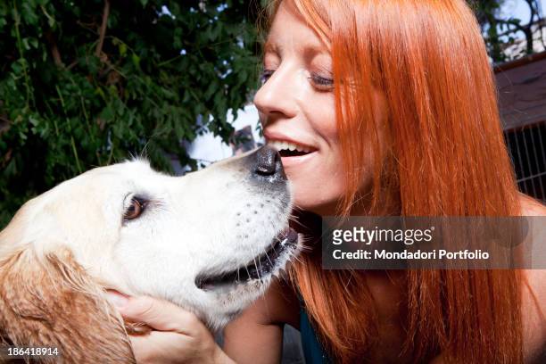Italian politician and animalist Michela Vittoria Brambilla caressing a Golden Retriever dog at the lido Bau Bau Village. Albisola Marina, 22nd...