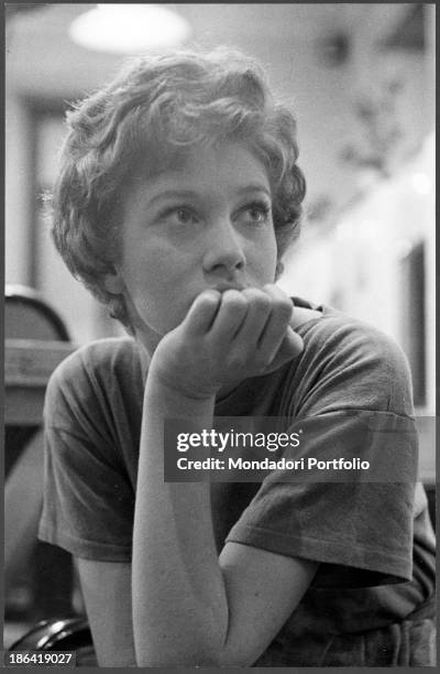 Italian actress Carla Gravina sitting with her hand under her chin. Rome, 1959.
