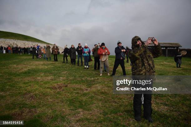 People take part in a sun rise ceremony during the Winter Solstice at Newgrange on December 21, 2023 in Newgrange, Ireland. Newgrange, a...