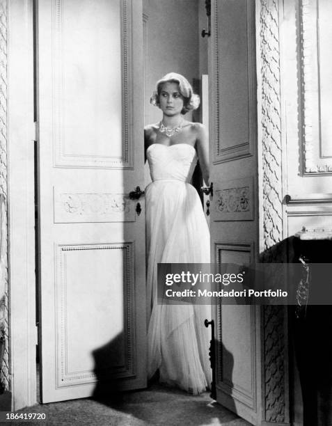 American actress and Princess consort of Monaco Grace Kelly wearing an evening dress in the film To Catch a Thief. USA, 1955.