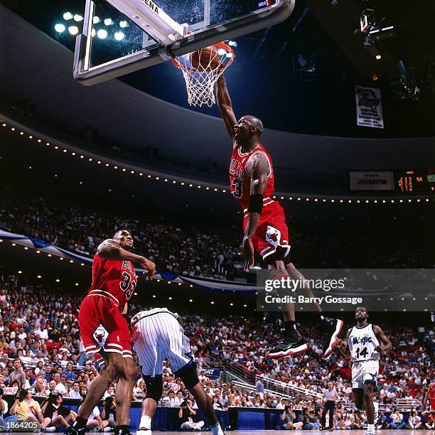 Michael Jordan of the Chicago Bulls goes for a dunk against the Orlando Magic during Game Four of the 1996 NBA Playoff Semifinals at Orlando Arena in...