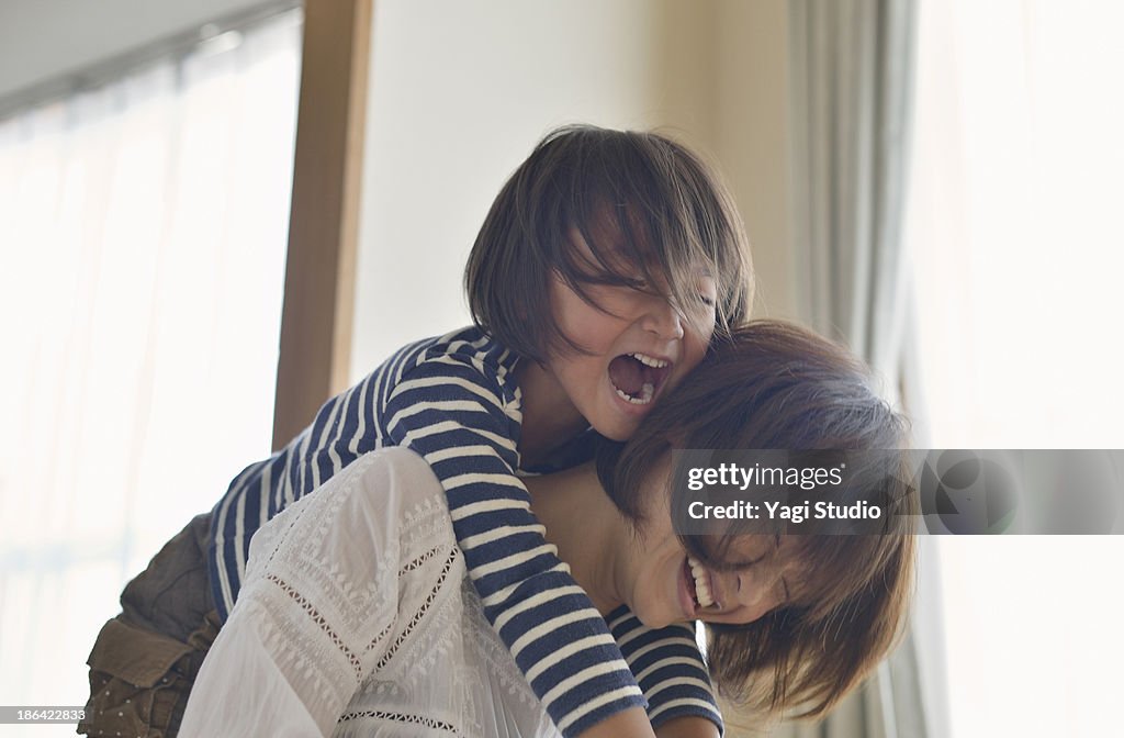 Daughter playing with Mother in the room
