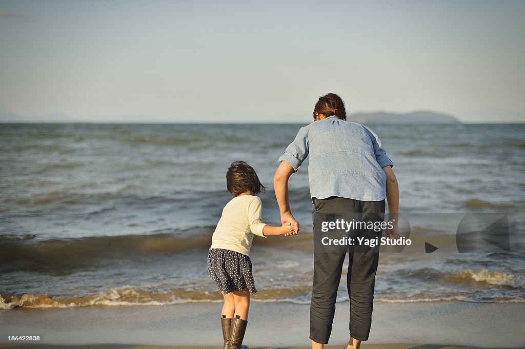 Mother and daughter playing on the beach