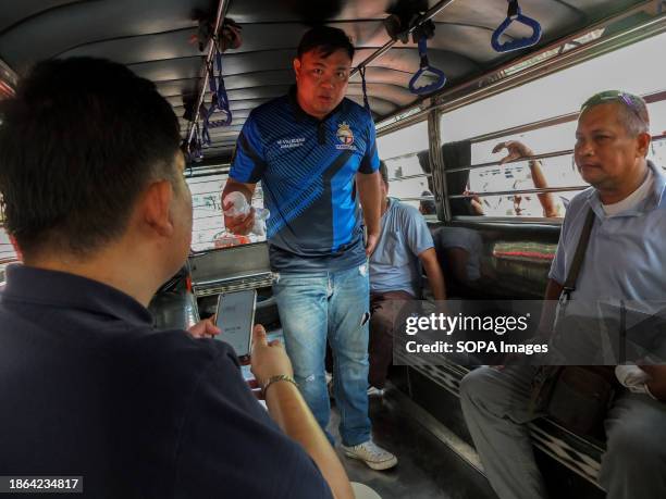 Manibela President, Mar Valbuena is interviewed by a news reporter inside their proposed version of modernized jeepney during the demontration....