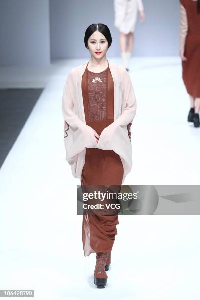 Model showcases designs by Lian Huiqing on the runway at the LIANVIS Lian Huiqing Collection show during Mercedes-Benz China Fashion Week...