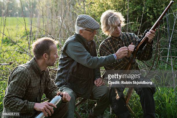 grandfather son and grandson with riffle - hunter stock pictures, royalty-free photos & images