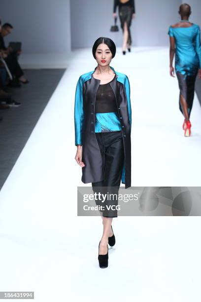 Model showcases designs by Lian Huiqing on the runway at the LIANVIS Lian Huiqing Collection show during Mercedes-Benz China Fashion Week...