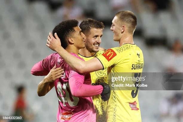 Alexander Paulsen, Scott Wootton and Finn Surman of the Phoenix celebrate victory during the A-League Men round eight match between Macarthur FC and...