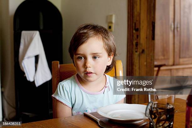 child sits on a table and looks nice and relaxed - hazel eyes stock pictures, royalty-free photos & images