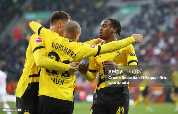 Donyell Malen of Borussia Dortmund celebrates with teammates after scoring his teams first goal during the Bundesliga match between FC Augsburg and...