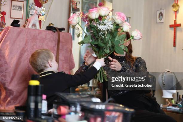 In this image released on December 21, 2023 Leonard Lacey-Krone gives his mother Jana Mandana Lacey-Krone roses during a family Portrait Shoot on...