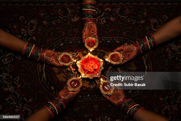 women celebrating diwali, festival of lights - india celebrates diwali festival stock pictures, royalty-free photos & images