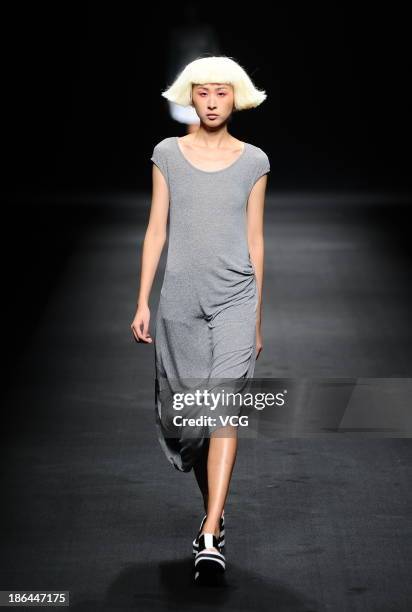 Model showcases designs by Wang Tao on the runway at the BROADCAST Wang Tao Collection show during Mercedes-Benz China Fashion Week Spring/Summer...