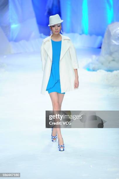 Model showcases designs by Liu Wei on the runway at the TORAY Liu Wei Collection show during Mercedes-Benz China Fashion Week Spring/Summer 2014 at...