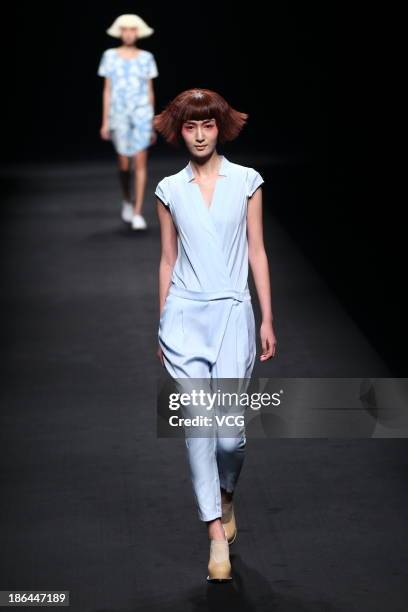 Model showcases designs by Wang Tao on the runway at the BROADCAST Wang Tao Collection show during Mercedes-Benz China Fashion Week Spring/Summer...