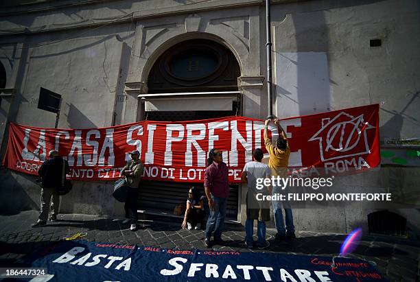 Protesters hold a banner reading "Take the house" during a demonstration to ask for affordable housings and against Government's austerity measures...