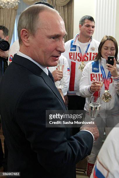 Russian President Vladimir Putin meets with athletes at a meeting with the winners of the 2013 World Combat Games October 31, 2013 in Moscow, Russia....