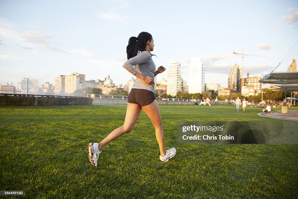 Woman running in park in the city