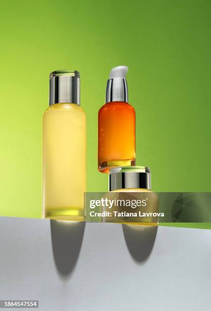 set of beautiful luxury cosmetics jars and bottles on trendy green yellow  background. beauty industry and skincare concept with copy space for text, design elements, logo. hero view - mousse para cabelos imagens e fotografias de stock