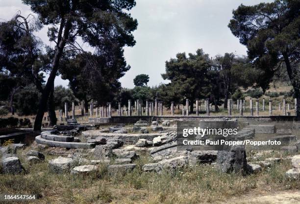 Ruins of an Ancient Greek temple, possibly the Temple of Zeus, and courtyard in the archaeological site of Olympia, located on the western part of...