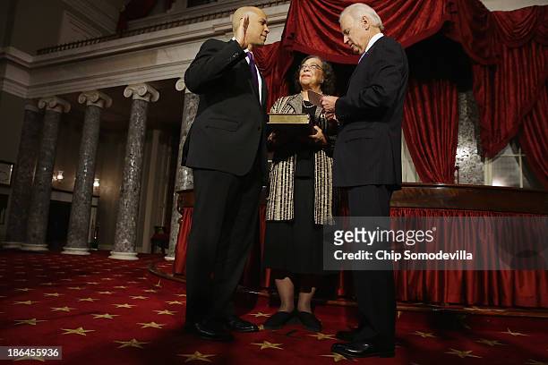 Vice President Joe Biden administers a ceremonial swearing for Sen. Cory Booker as his mother Carolyn Booker holds a Bible in the Old Senate Chamber...