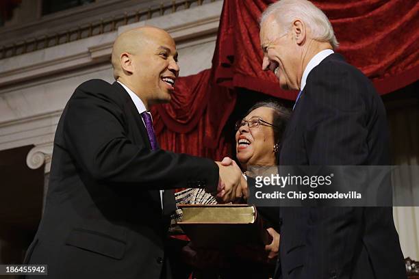 Vice President Joe Biden congratulates Sen. Cory Booker after administering a ceremonial swearing-in as his mother Carolyn Booker looks on in the Old...
