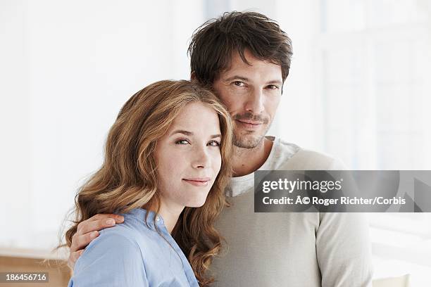 portrait of mid adult couple - couples studio portrait stock pictures, royalty-free photos & images