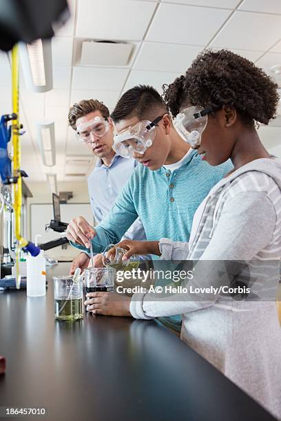 teacher with students (13-15) in chemistry class - teacher studio portrait stock pictures, royalty-free photos & images