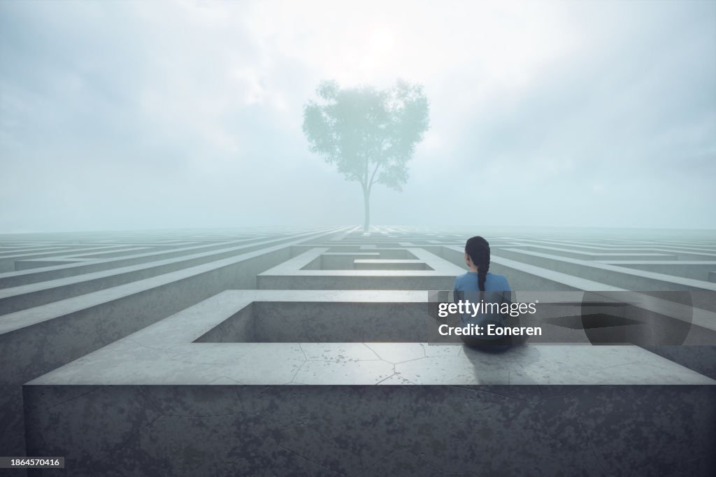 Young woman sitting on maze