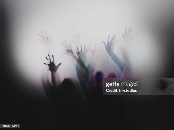 silhouette of people with raised hands - erlangen stock pictures, royalty-free photos & images