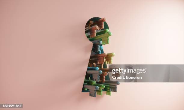 giant keyhole with variety of keys - chave imagens e fotografias de stock