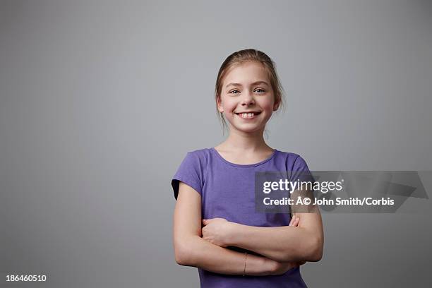 studio shot portrait of girl (10-12) in purple t-shirt - 12 year old blonde girl stock pictures, royalty-free photos & images