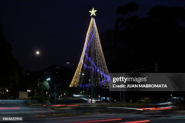 Christmas tree is seen on Figuero Alcorta Avenue at night in Buenos Aires on December 19, 2023. Latin America's third-biggest economy is on its knees...