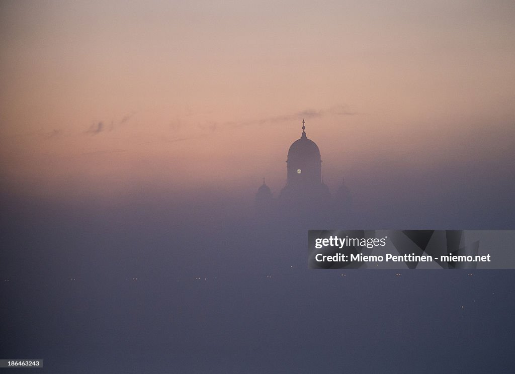 Helsinki Cathedral peeking from mist by dusk