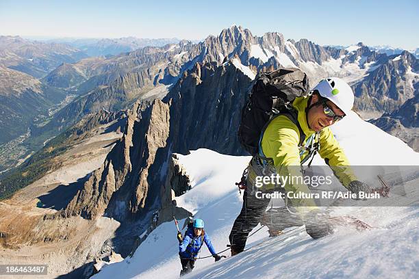 mid adult couple mountaineering, chamonix, haute savoie, france - chamonix stock pictures, royalty-free photos & images