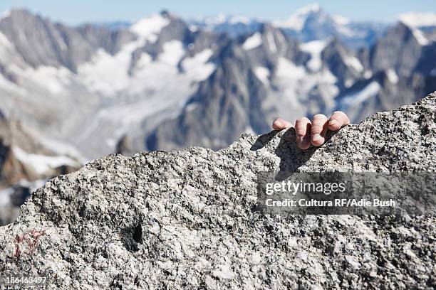 mountaineer 's hand on summit, close up - extreme close up fotografías e imágenes de stock