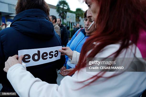 Protestor displays a sticker on a coat during a demonstration called by the Executive Council and Social Council in support for all employees of...