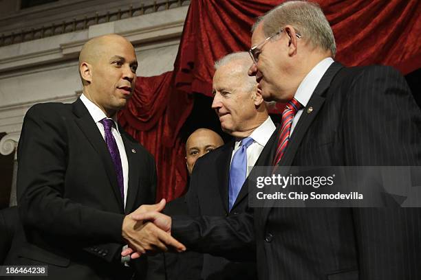 Sen. Cory Booker shakes hand with Sen. Robert Menendez after Booker's ceremonial swearing-in with Vice President Joe Biden in the Old Senate Chamber...