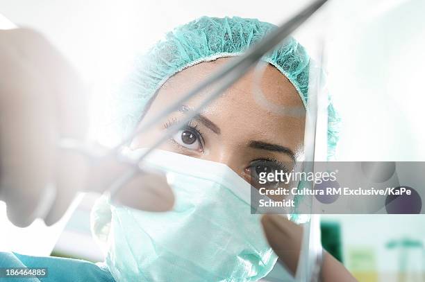 surgeon preparing surgical instrument - surgery stitches stock pictures, royalty-free photos & images